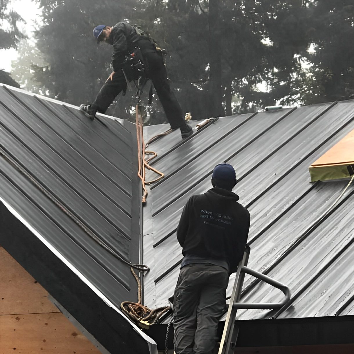 Workers installing a metal roof.