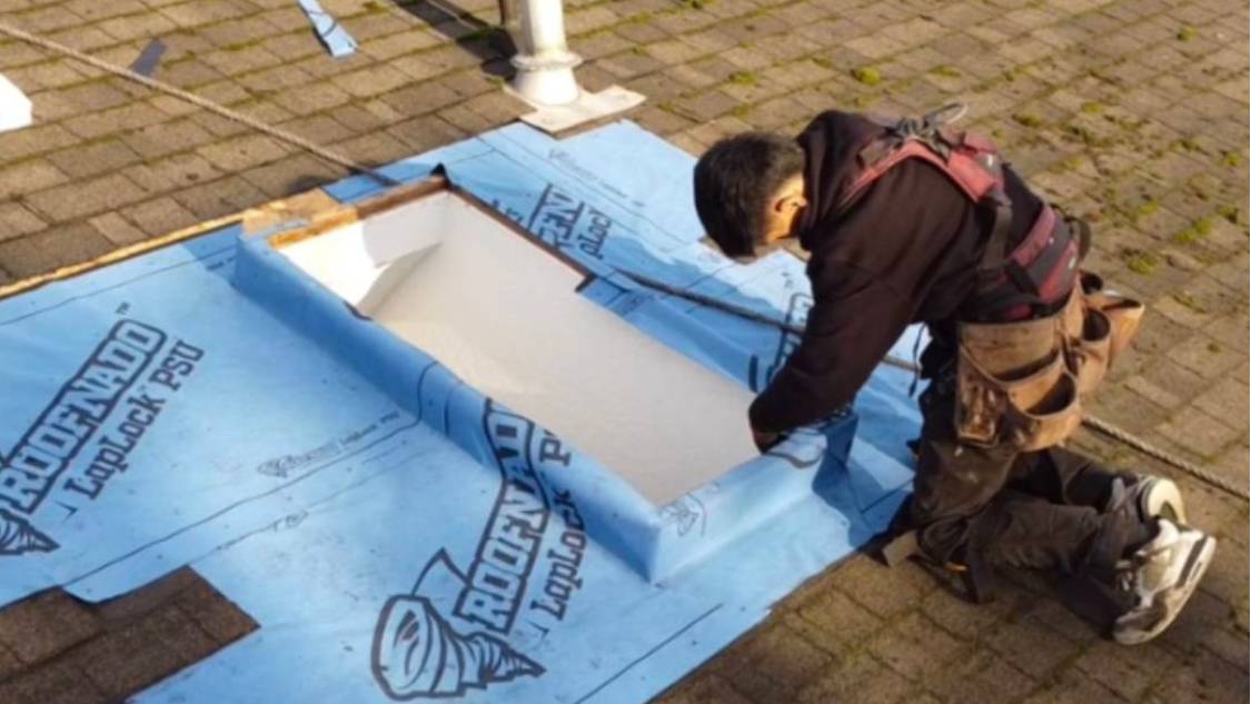 A man working on the roof of a building.