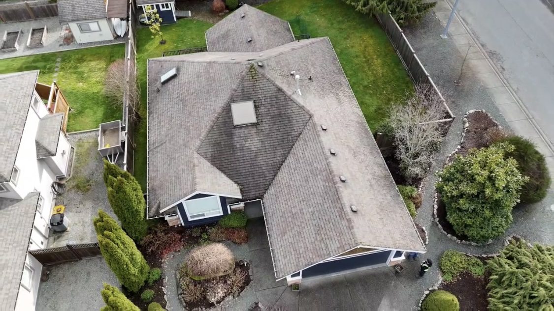 A house with a roof that has been cleaned.