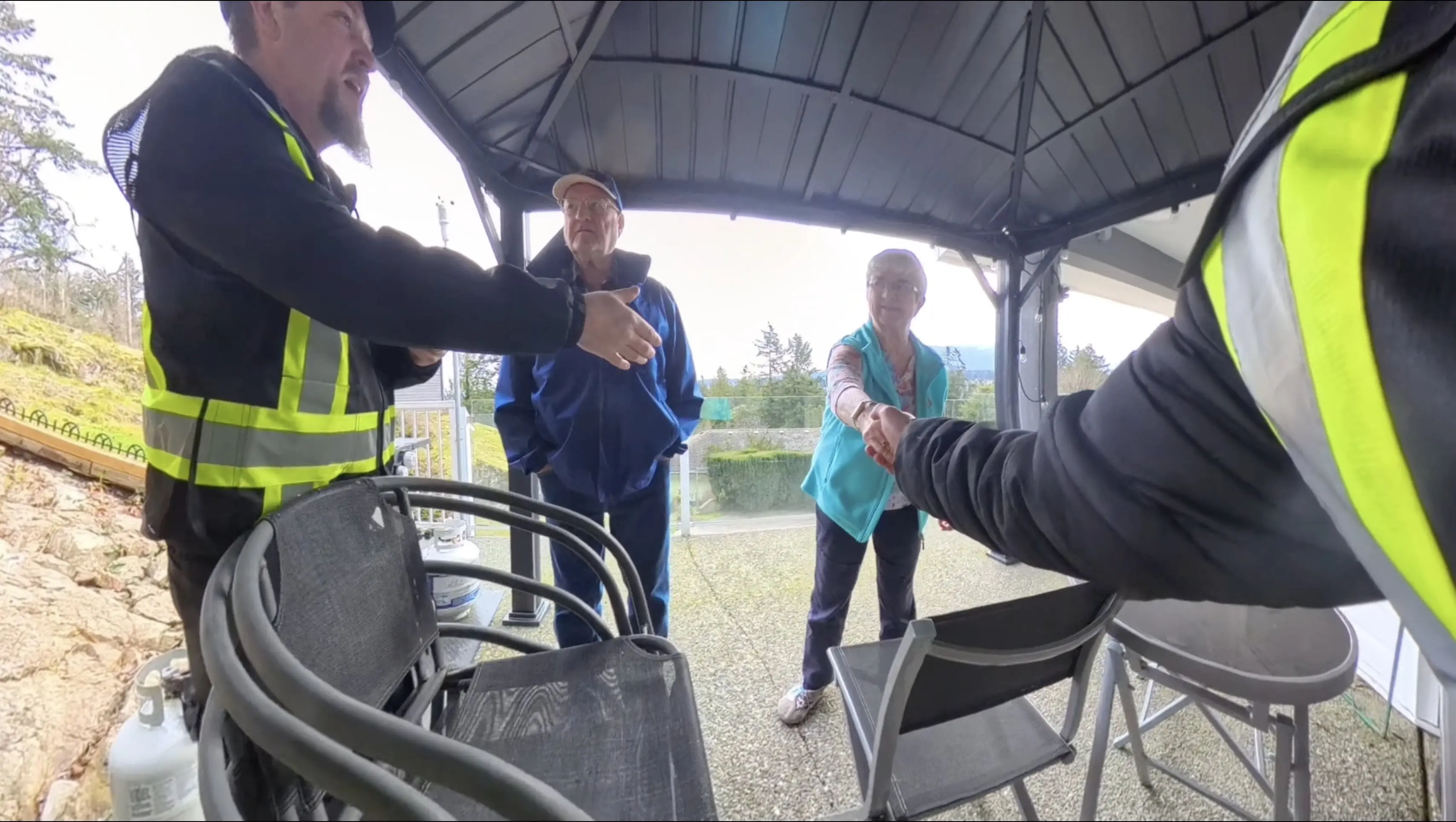 A group of people standing around shaking hands.
