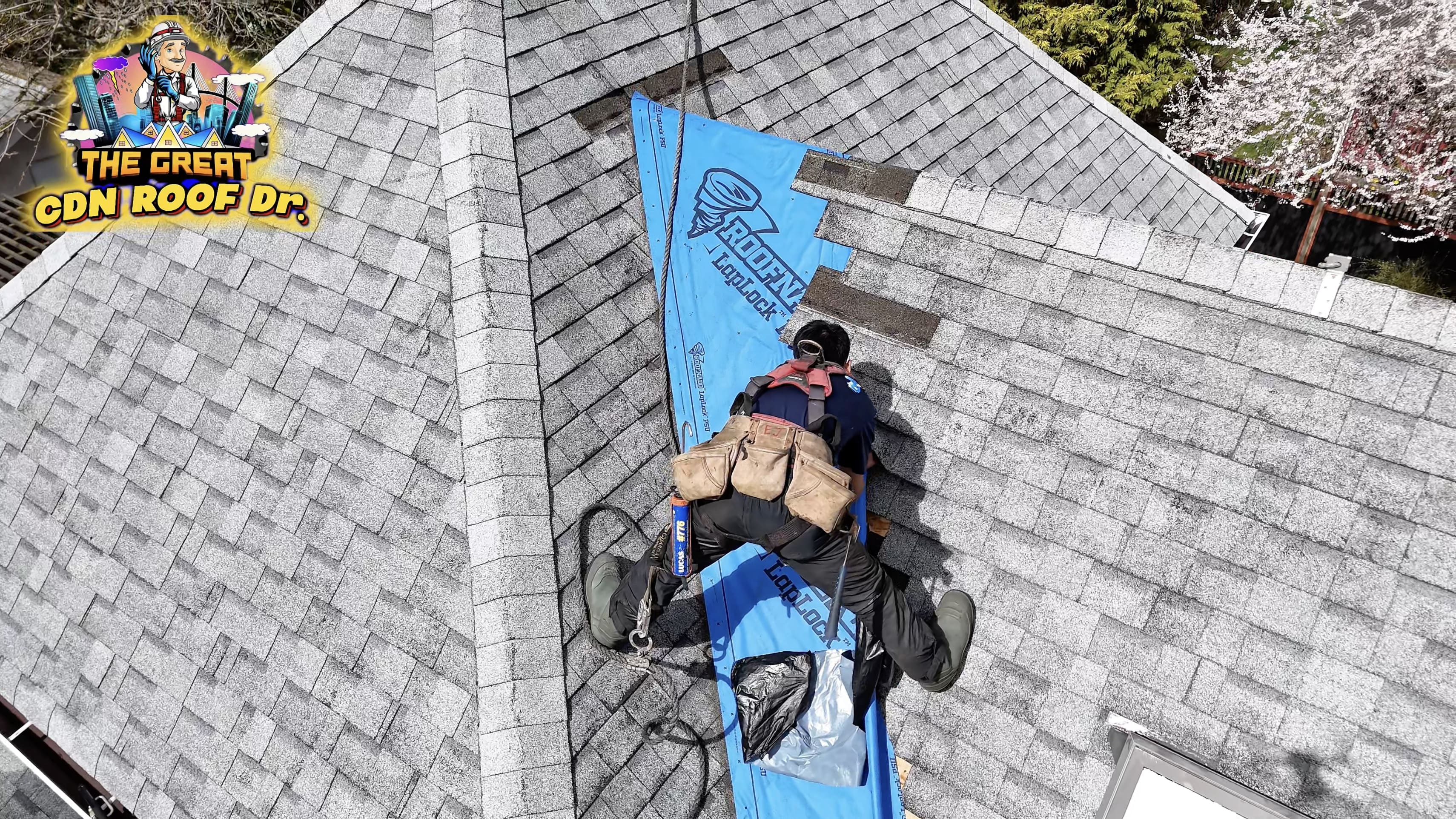 A man is hanging from the roof of his house.