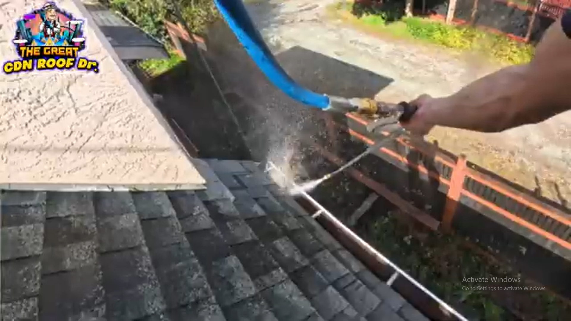 A person is cleaning the roof of a house.