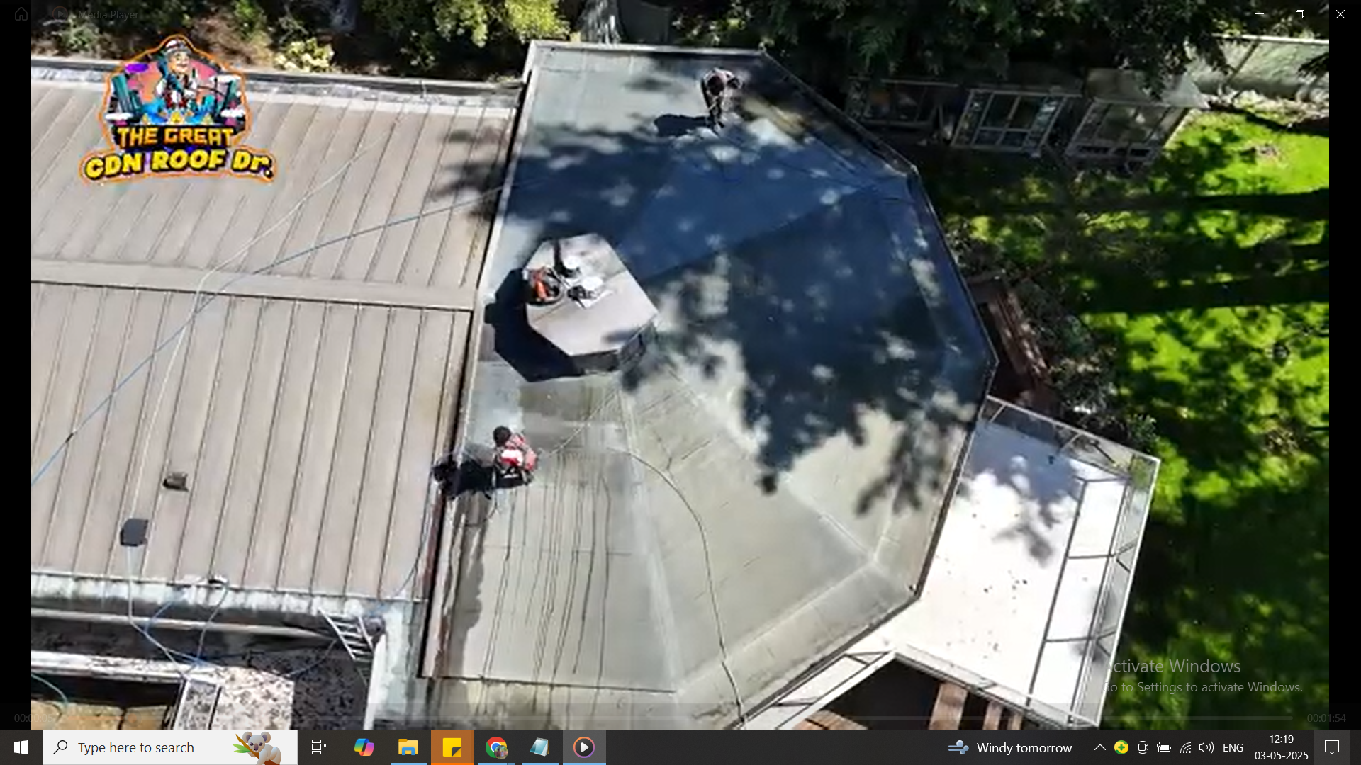 A person sitting on top of a roof.